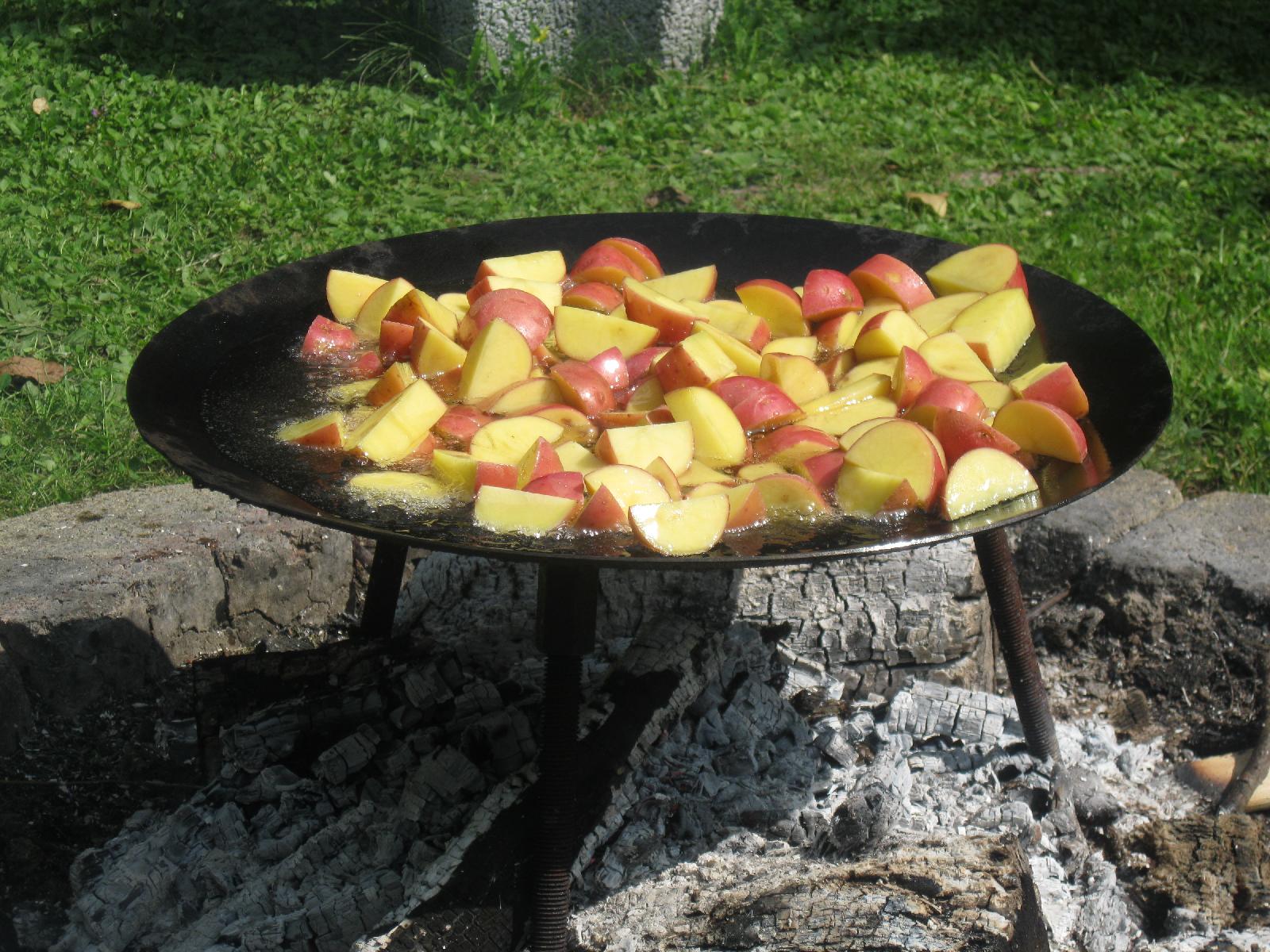 Potatoes frying over the firepit.